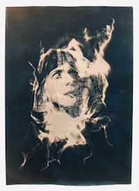 a black and white photo of a woman with smoke coming out of her face