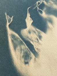 a black and white photo of a sand dune