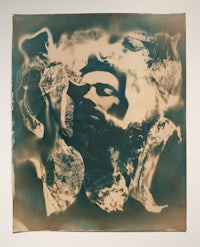 a black and white photo of a man with a beard